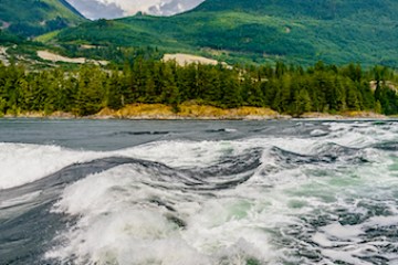 a body of water with a mountain in the background