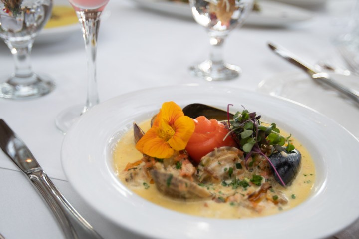 a plate of food and glasses of wine on a table