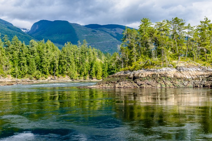 a body of water with a mountain in the background
