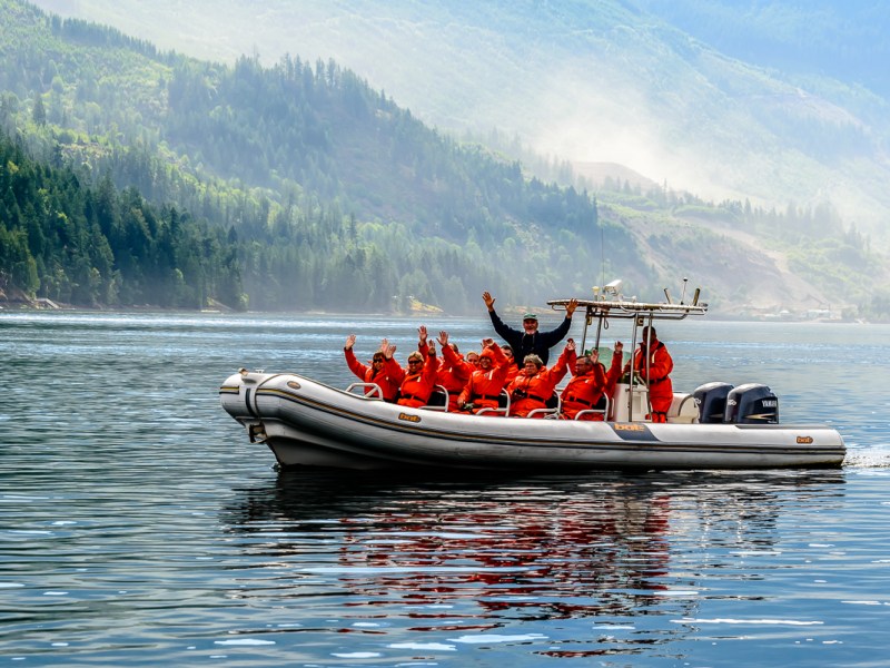 a group of people in a small boat in a body of water