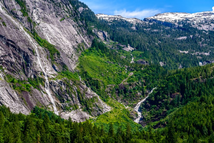 a waterfall with a mountain in the background