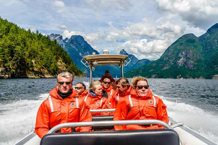 a group of people riding on the back of a boat