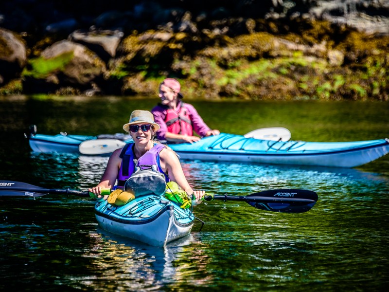 a man riding on the back of a boat in the water